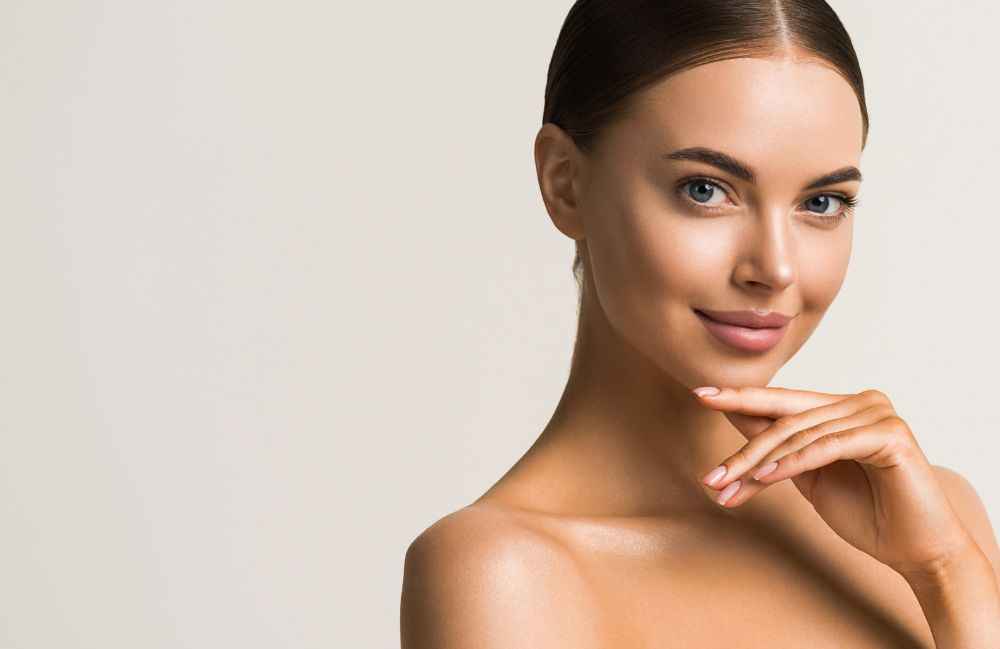 A woman receiving a relaxing Diamond Glow facial treatment.