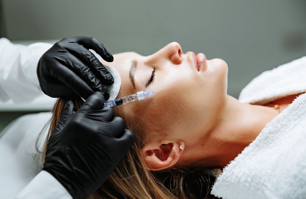 cheek_fillers_session Side-by-side comparison of a woman's neck before and after platysmal band injections.