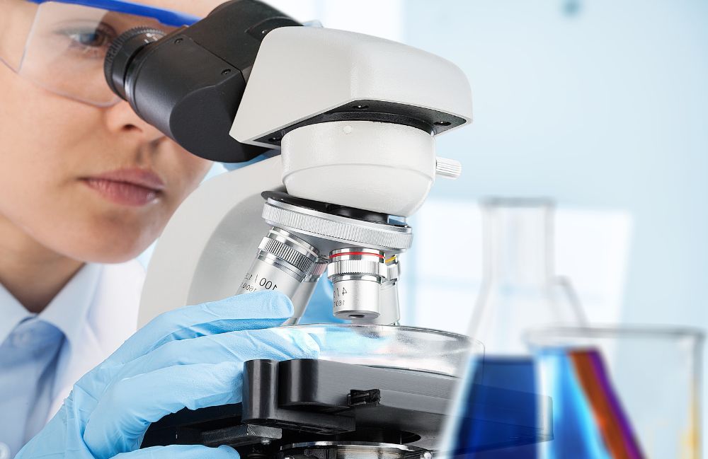 dermatopathology-pasadena-lab A dermatologist inspecting a skin biopsy with a magnifying glass during a dermatopathology evaluation in Costa Mesa.