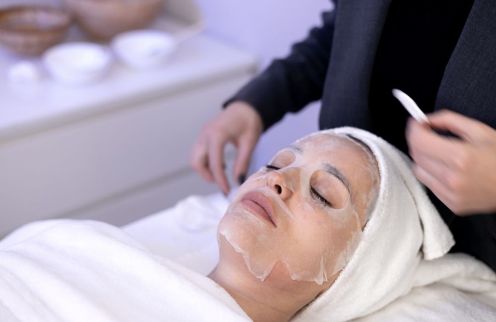 facial_mask_treatment Side-by-side comparison of a woman's neck before and after platysmal band injections.
