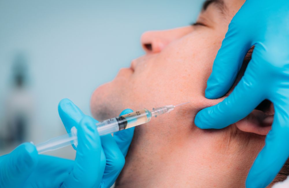 liquid_jawline_contouring Side-by-side comparison of a woman's neck before and after platysmal band injections.