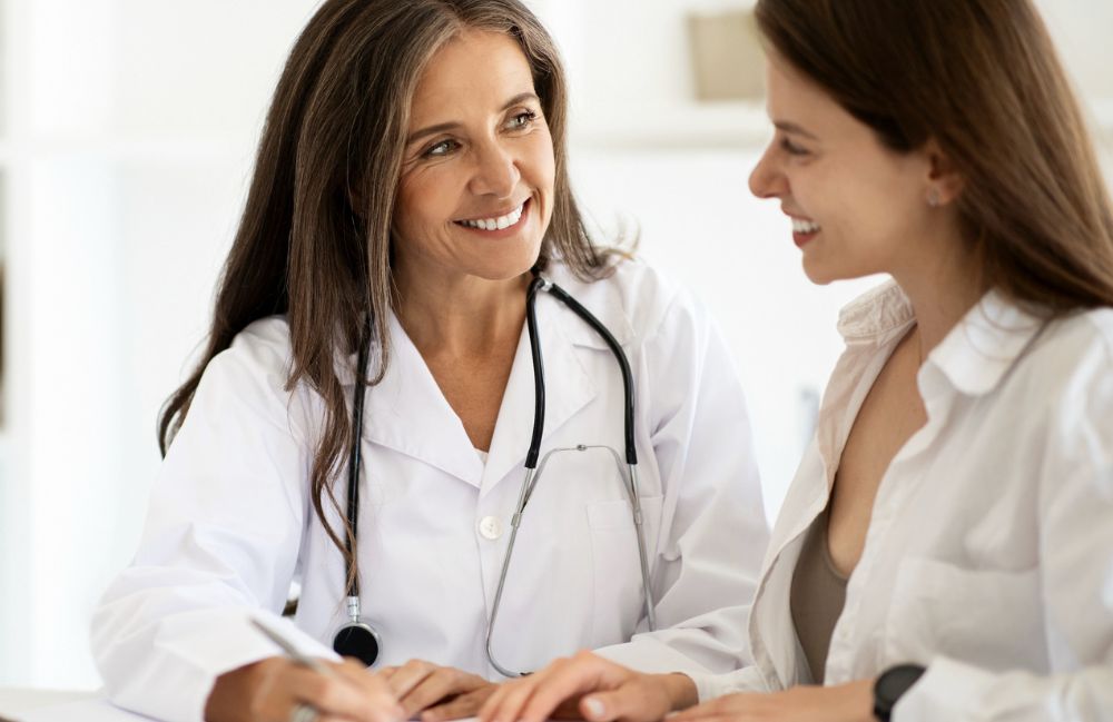 medical-consultation-pasadena-doctor A dermatologist examining a woman's skin during a consultation in Costa Mesa, focusing on facial concerns.
