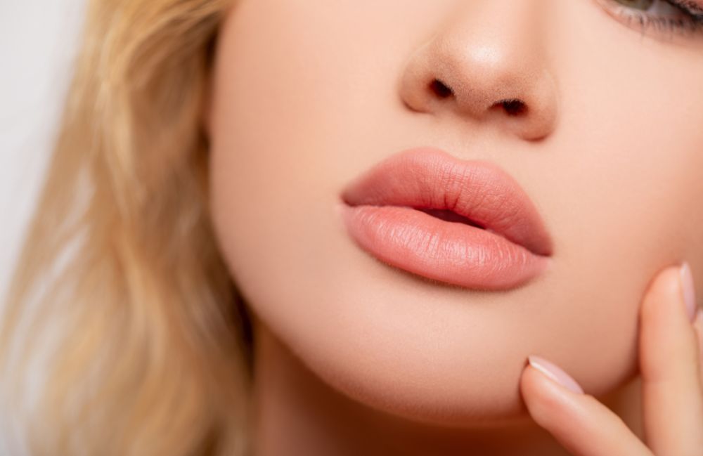 more_pout_with_lip_filler Close-up of a woman's neck showing visible platysmal bands before treatment.