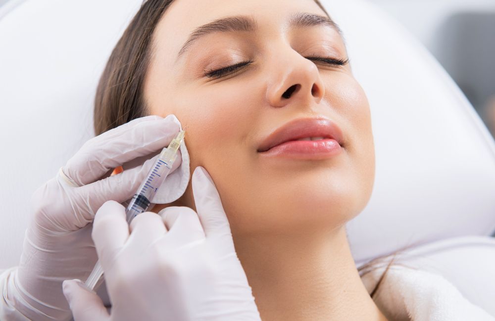rha_filler_session Side-by-side comparison of a woman's neck before and after platysmal band injections.